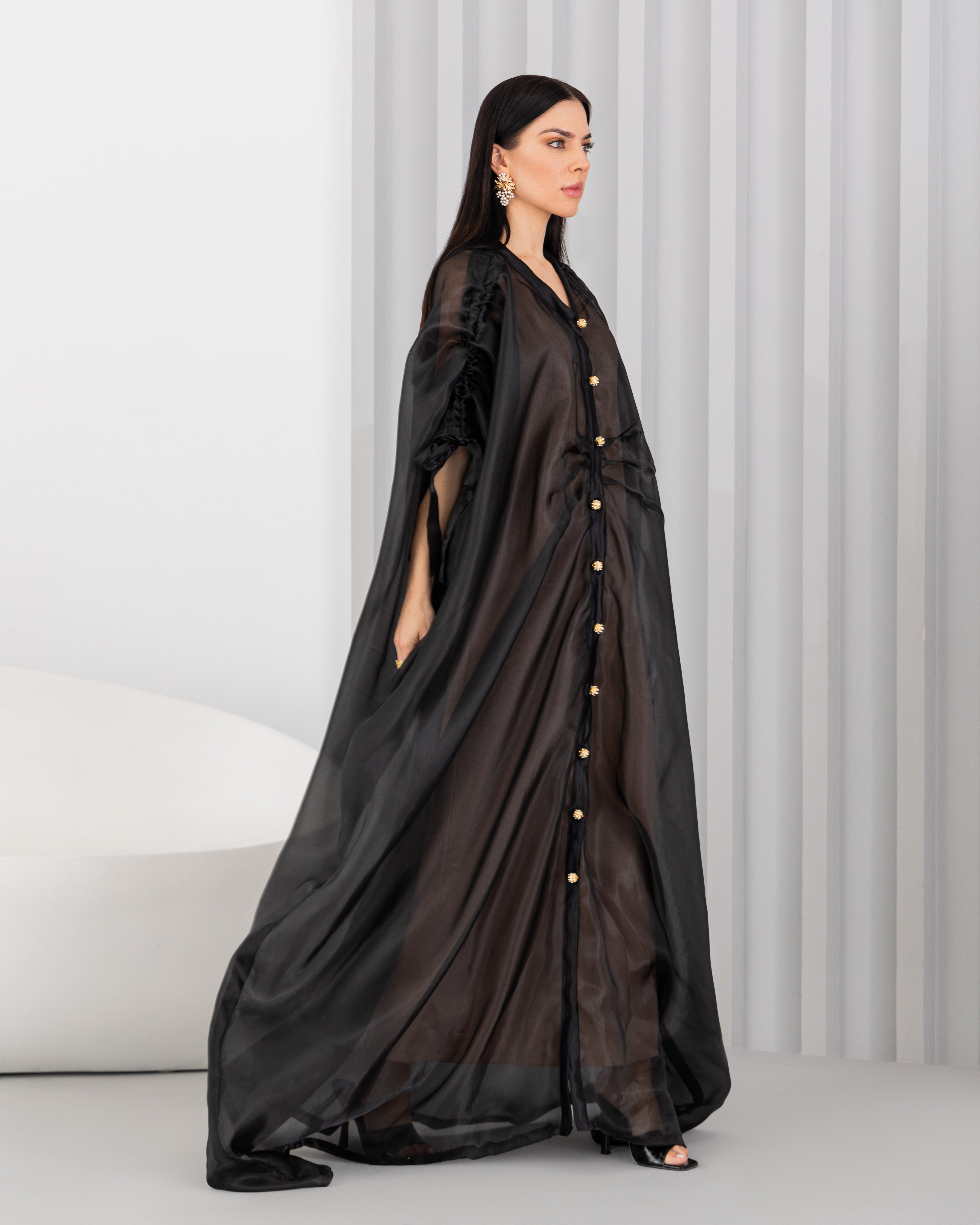 Sheer abaya with vintage buttons.